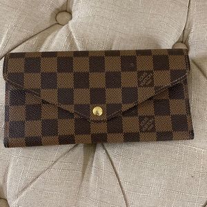 Louis Vuitton long wallet in Damier Ebene canvas with gold hardware